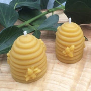 Small beeswax candle shaped as a traditional bee skep hive